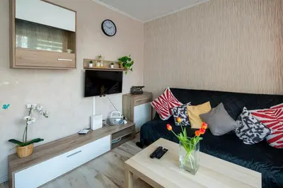 a living room with a couch and a table at Like home in Kraków
