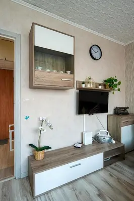 a living room with a table and a clock on the wall at Like home in Kraków