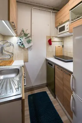 a small kitchen with a sink and a refrigerator at Like home in Kraków