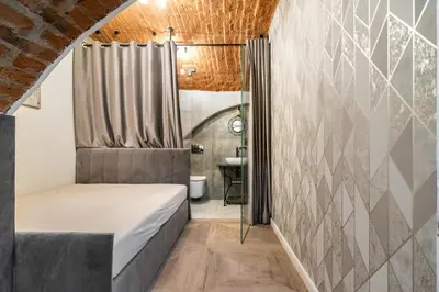 a bedroom with a bed and a shower at The Hidden Nook in Kraków