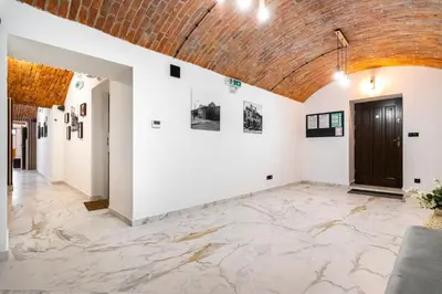 a room with white walls and a brick ceiling at The Hidden Nook in Kraków