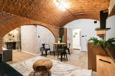 a room with a brick wall and a table and chairs at The Hidden Nook in Kraków