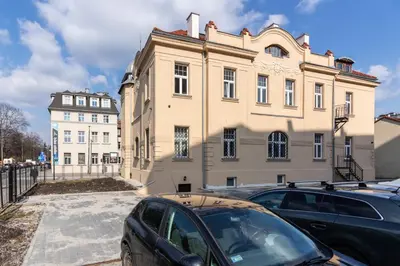 a large building with cars parked in front of it at The Hidden Nook in Kraków