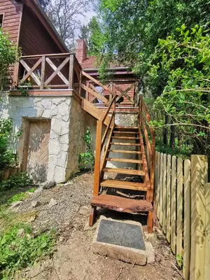 a wooden staircase leading up to a house at Domek Samotnia w ogrodzie in Kraków
