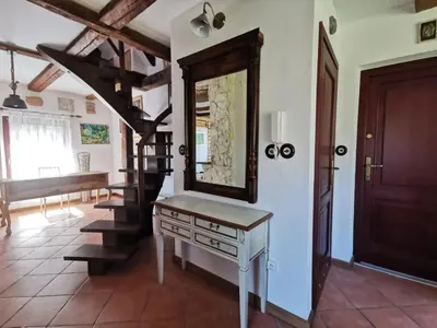 a dressing table with a mirror and a staircase in a room at Domek Samotnia w ogrodzie in Kraków