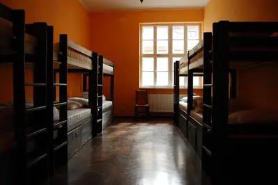 a room with four bunk beds and a window at The Little Havana Party Hostel in Kraków