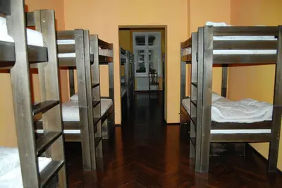 a room with several bunk beds in a room at The Little Havana Party Hostel in Kraków