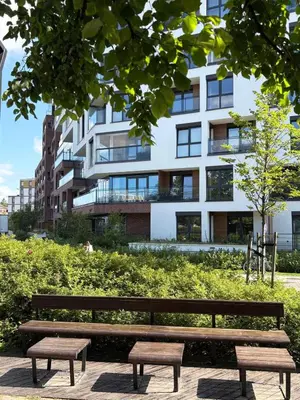 a park bench in front of a building at WLB Apartments in Kraków