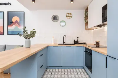a kitchen with blue cabinets and a sink at Stylowe Studio - Nowy Kleparz - Kraków - by Upstairs in Kraków