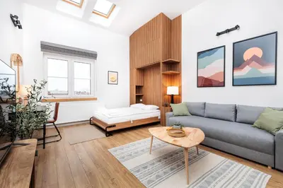 a living room with a couch and a table at Stylowe Studio - Nowy Kleparz - Kraków - by Upstairs in Kraków