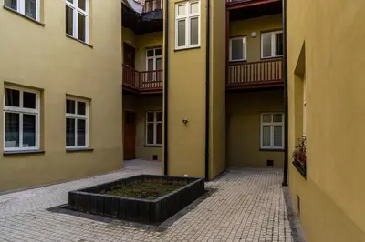 a courtyard with a planter in the middle of a building at Felicjanek 15 - Central 3-Bedroom Apartment - by Upstairs in Kraków
