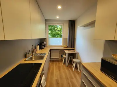 a kitchen with a sink and a counter top at Grey Apartment Kraków in Kraków