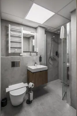 a bathroom with a toilet and a sink and a shower at Iron Street by A11 Sauna in Kraków