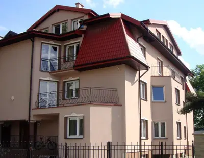 a large building with a red roof at Apartamenty Dolna Kraków in Kraków