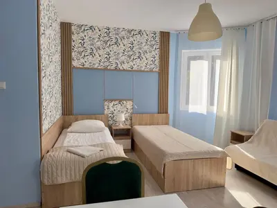 a small bedroom with two beds and a window at Apartamenty Dolna Kraków in Kraków