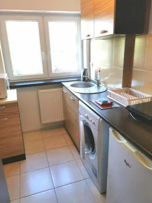 a kitchen with a washing machine and a sink at Apartamenty Dolna Kraków in Kraków
