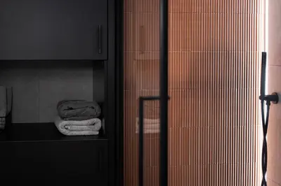 a bathroom with towels on a shelf in a bathroom at Bright and cosy flat near the river in Kraków