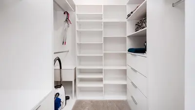 a white walk in closet with white shelves at Przedwiośnie, Sun & Snow in Kraków