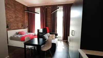 a bedroom with a bed and a desk and a table at Cracow Fancy Brick #1 - Old Town in Kraków