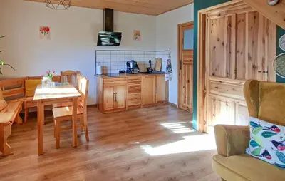 a kitchen and dining room with a table and chairs at 3 Bedroom Awesome Home In Barwald Dolny in Barwałd Dolny