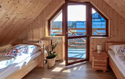a bedroom with two beds and a large window at 3 Bedroom Awesome Home In Barwald Dolny in Barwałd Dolny
