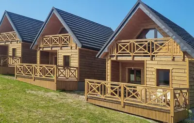 a wooden house with a black roof at 3 Bedroom Awesome Home In Barwald Dolny in Barwałd Dolny