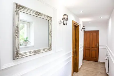 a mirror on the wall of a hallway with a door at Pokoje Gościnne - Za Borem in Zubrzyca Górna