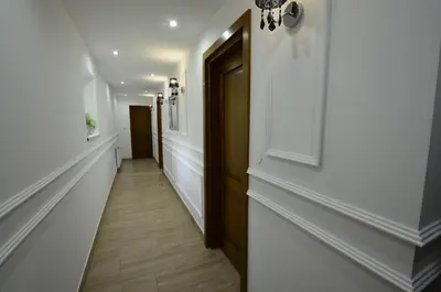 a hallway with white walls and a wooden door at Pokoje Gościnne - Za Borem in Zubrzyca Górna