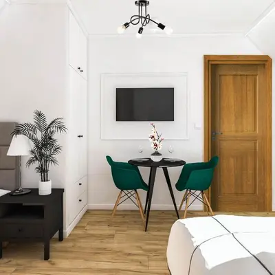 a bedroom with a table and chairs and a tv at Pokoje Gościnne - Za Borem in Zubrzyca Górna