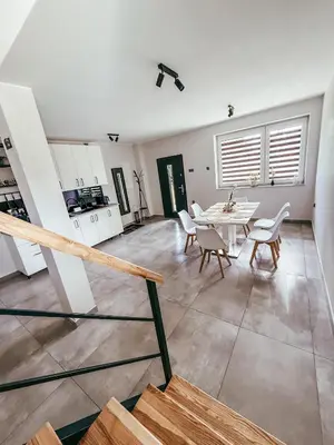 a kitchen and dining room with a table and chairs at Zosieńka in Podolsze
