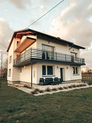 a house with a balcony on the side of it at Zosieńka in Podolsze