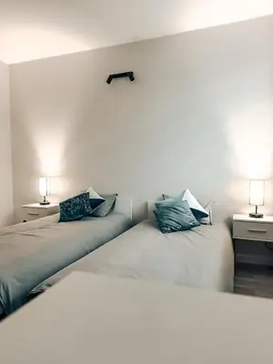 two beds sitting next to each other in a room at Zosieńka in Podolsze