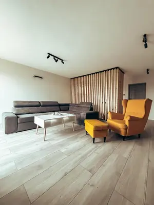 a living room with a couch and a table at Zosieńka in Podolsze