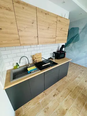 a kitchen with a sink and a counter top at Twoje prywatne SPA - jacuzzi, sauna, tężnia solankowa in Kraków
