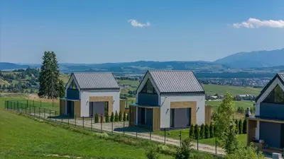 a row of houses on top of a hill at Domki z Widokiem Klikuszowa jacuzzi in Klikuszowa