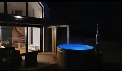 a dark room with a blue table and chairs at Domki z Widokiem Klikuszowa jacuzzi in Klikuszowa