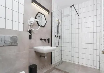 a bathroom with a sink and a shower at Golden Honey Apartments in Kraków