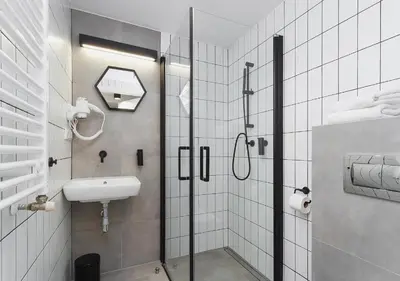 a bathroom with a shower and a sink at Golden Honey Apartments in Kraków