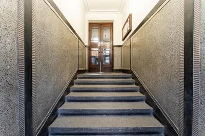 a hallway with stairs in a building at Park Kleparski Comfort Studio by BookingHost in Kraków