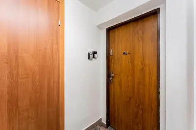 a wooden door in a white room with at Park Kleparski Comfort Studio by BookingHost in Kraków