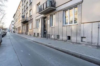 an empty street in front of a building at Park Kleparski Comfort Studio by BookingHost in Kraków