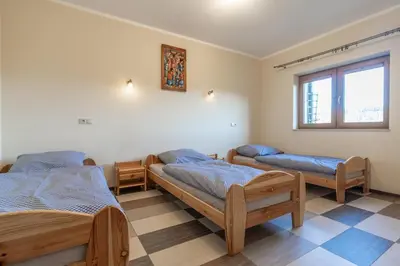 a room with three beds and a window at Górski Dom dla 30 osób z sauna oraz salą do integracji in Kocierz Rychwałdzki