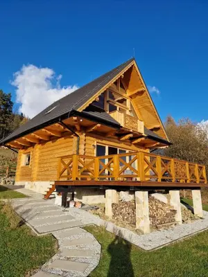 a large wooden cabin with a black roof at Dom z Bali Zawoja z widokiem na Babią Górę in Stryszawa