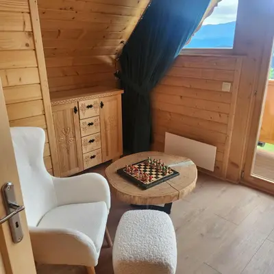 a room with a chessboard on a table and chairs at Dom z Bali Zawoja z widokiem na Babią Górę in Stryszawa