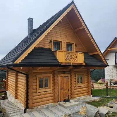 a log cabin with a balcony on top of it at Dom z Bali Zawoja z widokiem na Babią Górę in Stryszawa