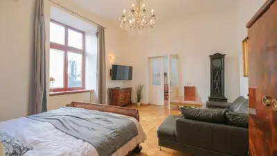 a living room with a white couch and a table at Vintage apartments Floriańska street - By Hosty in Kraków