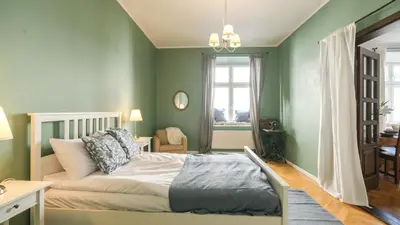 a hallway with a wooden door and a staircase at Vintage apartments Floriańska street - By Hosty in Kraków