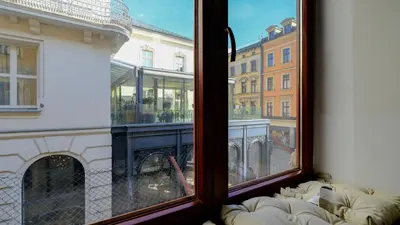 a dining room table with plates and a vase with flowers at Vintage apartments Floriańska street - By Hosty in Kraków
