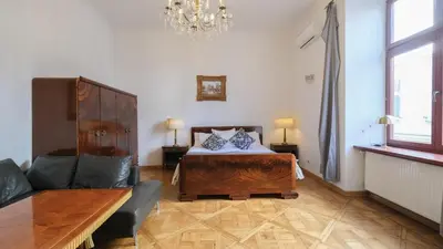 a bedroom with a large bed and a couch at Vintage apartments Floriańska street - By Hosty in Kraków