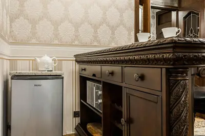 a kitchen with a stove and a refrigerator at Exclusive Royal Apartments in Kraków